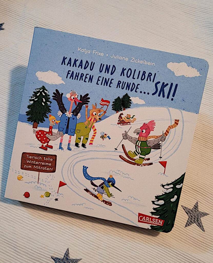 Das Pappbilderbuch „Kakadu und Kolibri fahren eine Runde ... Ski“ von Katja Frixe und Juliane Zickelbein